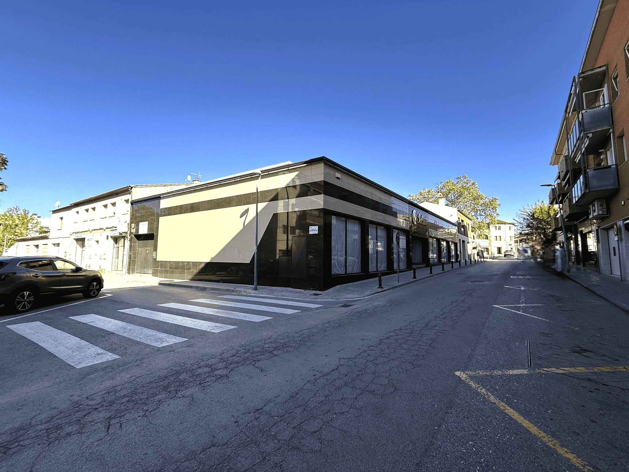 ALT de la imatge: Imatge d’un local comercial en una cantonada a Palau-solità i Plegamans, amb grans finestres i accés a peu de carrer, ideal per a negocis i serveis.